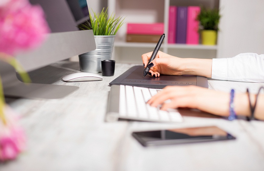 Designer's workspace in office with computer and drawing pad